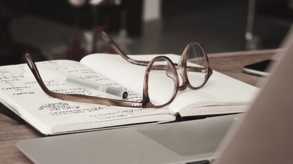 decorative image: glasses on notebook